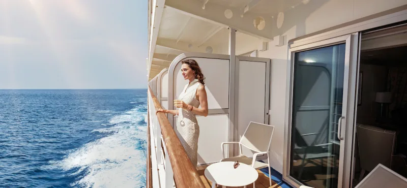 Lady on the balcony of her Veranda Suite, Silver Muse