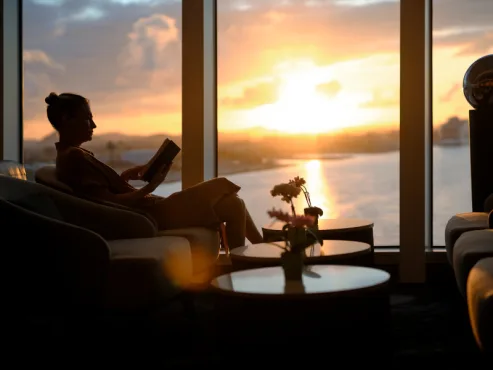 SSC_RA_Onboard Interior_Observation Lounge_043_013_V1a_Guest Reading a Book at Sunset_RGB_11648 x 8736